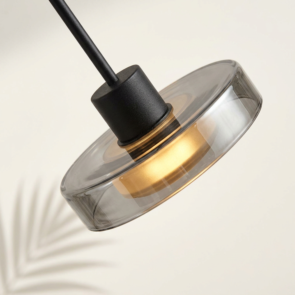 Zoom sur le verre fumé et la lumière chaude de la suspension — Navula